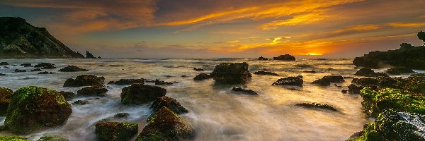 Skały, Morze, Kamienie, Zachód słońca, Plaża Adraga, Portugalia