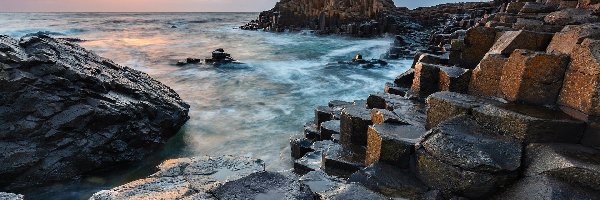 Chmury, Skały, Irlandia Północna, Antrim, Zachód słońca, Formacja Giants Causeway, Grobla Olbrzyma, Morze